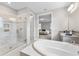 Bathroom with a large glass enclosed shower, garden tub, and dual sink vanity at 9947 Summerlake Groves St, Winter Garden, FL 34787