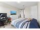 This carpeted bedroom features a TV, ensuite bathroom, and a closet at 9947 Summerlake Groves St, Winter Garden, FL 34787