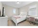 Bright bedroom showcasing a cozy bed and desk setup at 9947 Summerlake Groves St, Winter Garden, FL 34787