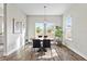 Bright dining room featuring a round wood table, stylish chandelier, and natural light from large windows at 9947 Summerlake Groves St, Winter Garden, FL 34787