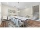 Dining room with modern chandelier, stylish wall art, and stairs leading to upper level at 9947 Summerlake Groves St, Winter Garden, FL 34787