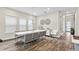 Bright dining room featuring seating for eight, stylish wall art, and an adjacent entry area at 9947 Summerlake Groves St, Winter Garden, FL 34787