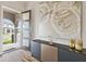 Elegant foyer showcasing modern decor, stylish console, and natural light from the front door at 9947 Summerlake Groves St, Winter Garden, FL 34787