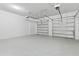 Spacious, clean garage with ample room for parking and storage, featuring two garage doors at 9947 Summerlake Groves St, Winter Garden, FL 34787