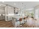 Open-concept kitchen with granite countertops, stainless appliances, and a seamless flow to dining area at 9947 Summerlake Groves St, Winter Garden, FL 34787