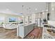 Modern kitchen with an island, stainless steel appliances, and an open view to the living room at 9947 Summerlake Groves St, Winter Garden, FL 34787