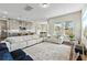 Open-concept living area with a large sectional sofa and seamless flow to the modern kitchen at 9947 Summerlake Groves St, Winter Garden, FL 34787