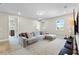Spacious loft with plush carpet, a comfortable sectional sofa, and plenty of natural light at 9947 Summerlake Groves St, Winter Garden, FL 34787