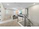 Upstairs loft featuring a cozy seating area, plush carpet, and a staircase with metal railings at 9947 Summerlake Groves St, Winter Garden, FL 34787