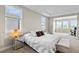 Cozy main bedroom with plush carpeting, dual windows, stylish furnishings, and adjacent sitting area at 9947 Summerlake Groves St, Winter Garden, FL 34787
