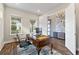 Bright home office with large windows, classic desk, and modern accents at 9947 Summerlake Groves St, Winter Garden, FL 34787