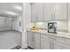 Convenient pantry featuring modern cabinets, granite countertops, and direct access to garage at 9947 Summerlake Groves St, Winter Garden, FL 34787
