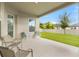 Covered patio with chairs overlooking a well-manicured lawn and bright, sunny backyard at 9947 Summerlake Groves St, Winter Garden, FL 34787