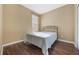 Simple bedroom includes a window and a comfy double bed with wooden floors at 11564 Mizzon Dr # 305, Windermere, FL 34786