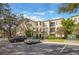 Multi-story condo building with reserved parking and lush landscaping, providing a welcoming curb appeal at 11564 Mizzon Dr # 305, Windermere, FL 34786