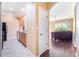 Hallway showcasing the entry to the kitchen and a view into the living room, highlighting the home's layout at 11564 Mizzon Dr # 305, Windermere, FL 34786