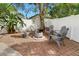 Backyard patio area with pavers, fire pit, six chairs, plants, and fenced yard at 1296 Bridlebrook Dr, Casselberry, FL 32707