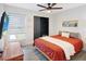 This cozy bedroom features a ceiling fan, closet, natural light, and an orange bed at 1296 Bridlebrook Dr, Casselberry, FL 32707