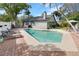 Backyard swimming pool with brick patio, surrounded by lush greenery and lounge chairs at 1296 Bridlebrook Dr, Casselberry, FL 32707