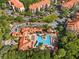 Aerial view of a community pool, multiple buildings, and landscaping offering a resort-style living experience at 1361 Tuscan Ter # 7105, Davenport, FL 33896