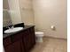 A primary bathroom featuring a dark vanity, large mirror, and tile floors at 1361 Tuscan Ter # 7105, Davenport, FL 33896