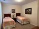 This bedroom offers twin beds with neutral walls and carpeted floors at 1361 Tuscan Ter # 7105, Davenport, FL 33896