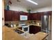 Open-concept kitchen features stainless steel appliances and granite countertops at 1361 Tuscan Ter # 7105, Davenport, FL 33896