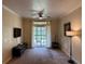 Inviting living room featuring neutral carpet, sliding door and a patio at 1361 Tuscan Ter # 7105, Davenport, FL 33896