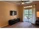 Comfortable living room with neutral carpet and a sliding door to the outside at 1361 Tuscan Ter # 7105, Davenport, FL 33896