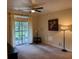 Bright living room with neutral carpet, sliding door and a patio at 1361 Tuscan Ter # 7105, Davenport, FL 33896