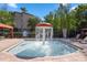 Community splash pool with a mushroom fountain and surrounding lounge chairs at 1361 Tuscan Ter # 7105, Davenport, FL 33896