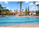 Resort-style swimming pool surrounded by palm trees and comfortable lounge areas at 1361 Tuscan Ter # 7105, Davenport, FL 33896