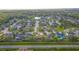 An aerial view of a neighborhood featuring a mix of houses, surrounded by lush greenery and a serene lake at 1411 Ellis Fallon Loop, Oviedo, FL 32765