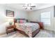 Cozy bedroom features hardwood floors, neutral walls, soft bedding, and natural light from a window at 1411 Ellis Fallon Loop, Oviedo, FL 32765