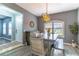 Charming dining room featuring stylish lighting, a rustic table, and shuttered windows at 1411 Ellis Fallon Loop, Oviedo, FL 32765