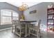 Bright dining area with modern light fixture, a large dining table, and window shutters at 1411 Ellis Fallon Loop, Oviedo, FL 32765