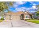 A beautiful home with a stone facade, well-kept lawn, and a spacious three-car garage at 1411 Ellis Fallon Loop, Oviedo, FL 32765