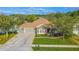 Aerial view of a well-maintained home showcasing the landscaped front yard and spacious driveway at 1411 Ellis Fallon Loop, Oviedo, FL 32765