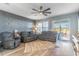 Inviting living room features a decorative wall, a ceiling fan, and a sliding door to the outdoor area at 1411 Ellis Fallon Loop, Oviedo, FL 32765