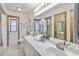 Bright bathroom with dual sinks, white cabinetry, and ample mirror space at 1432 Northridge Dr, Longwood, FL 32750