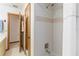 Well-lit bathroom featuring a shower and convenient access to adjacent areas at 1432 Northridge Dr, Longwood, FL 32750