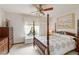 Cozy bedroom featuring a four poster bed, complemented by natural light and a ceiling fan at 1432 Northridge Dr, Longwood, FL 32750