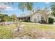 Home exterior featuring a screened lanai, lush lawn, and landscaped yard at 1432 Northridge Dr, Longwood, FL 32750