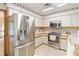 Corner kitchen view featuring white cabinets, tile backsplash, and stainless steel appliances at 1432 Northridge Dr, Longwood, FL 32750