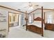 Spacious main bedroom with a four-poster bed, and an adjoining bathroom at 1432 Northridge Dr, Longwood, FL 32750