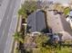 Aerial view of a home with a dark roof, fenced yard, a patio, and a palm tree at 1493 Hyde Park Dr, Winter Park, FL 32792