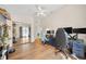 Open bedroom featuring wood floors, a ceiling fan, and a mirrored closet at 1493 Hyde Park Dr, Winter Park, FL 32792