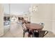 Open-concept dining area with tile flooring, modern lighting, and views into living room at 1493 Hyde Park Dr, Winter Park, FL 32792