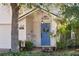 Close-up view of front door with blue paint, wreath and decorative plants at 1493 Hyde Park Dr, Winter Park, FL 32792