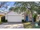 Charming single-story home featuring a well-manicured lawn, brick facade, and a welcoming blue front door at 1493 Hyde Park Dr, Winter Park, FL 32792